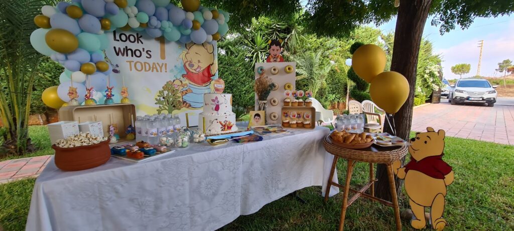 a table with food and balloons on it