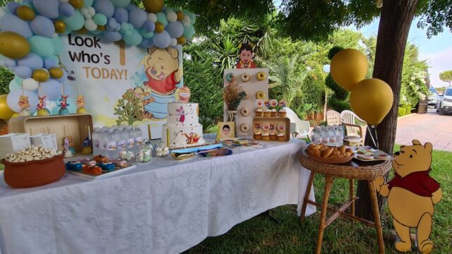 a table with food and balloons on it