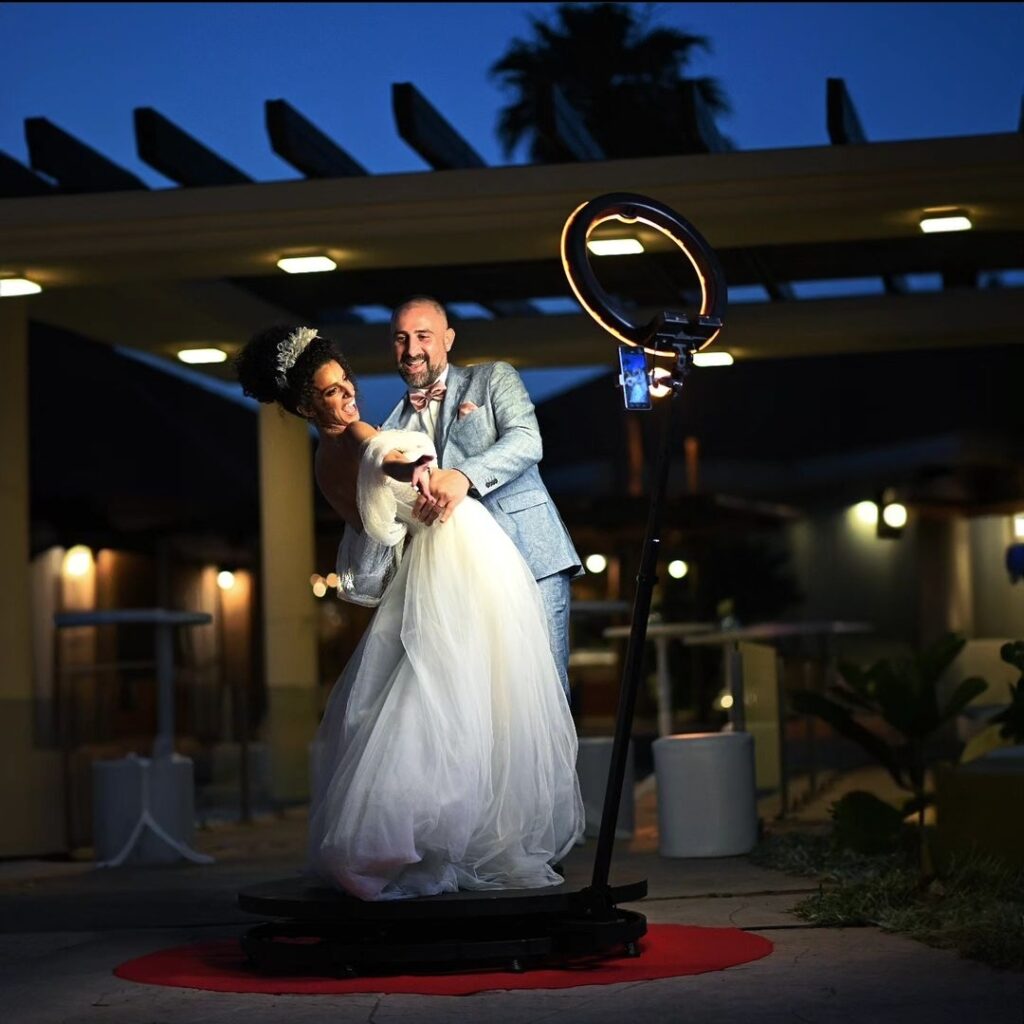 A man and woman in wedding attire enjoy a fun-filled moment at the PuzzleBooth.