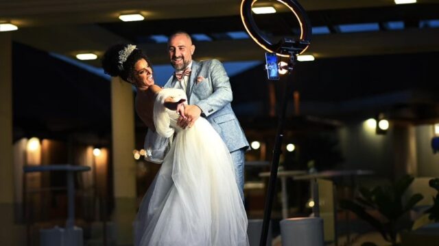 A man and woman in wedding attire enjoy a fun-filled moment at the PuzzleBooth.