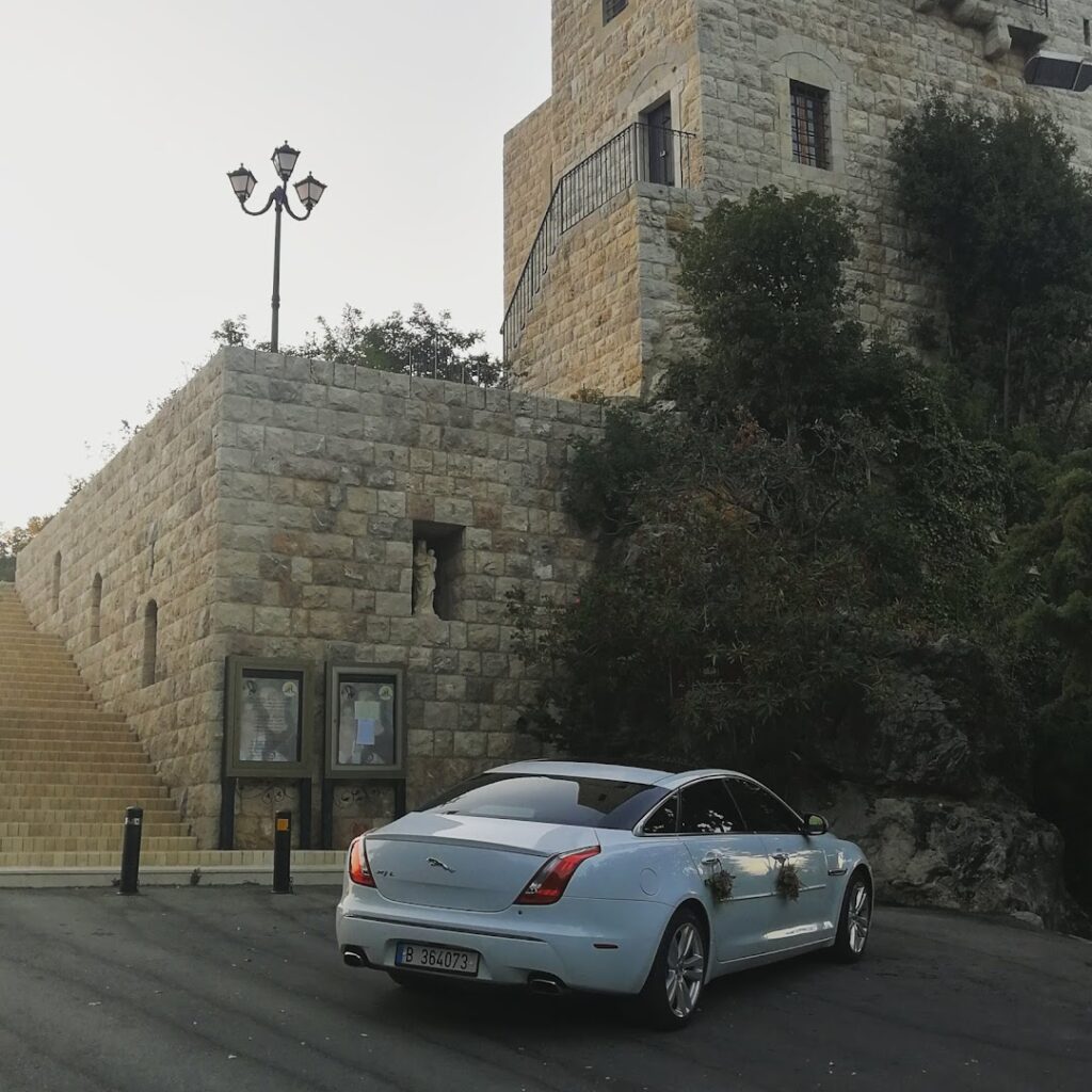 a car parked in front of a stone building