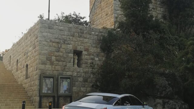 a car parked in front of a stone building