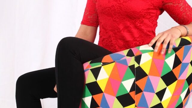 a woman sitting on a colorful chair