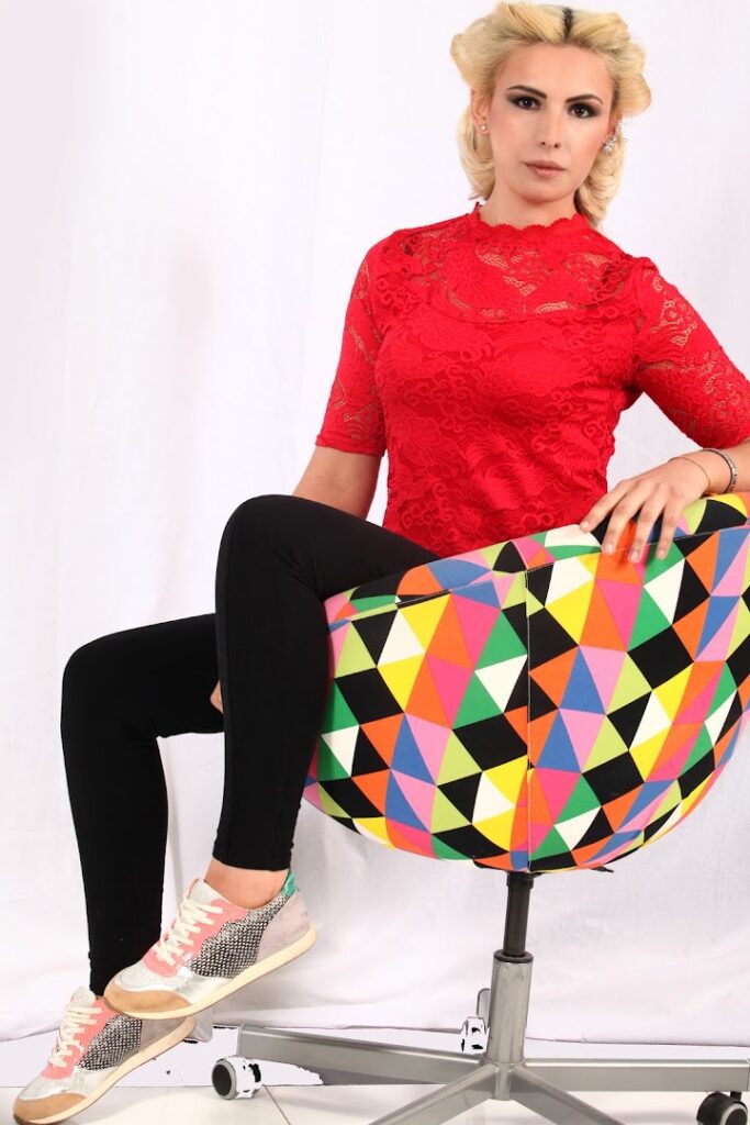 a woman sitting on a colorful chair