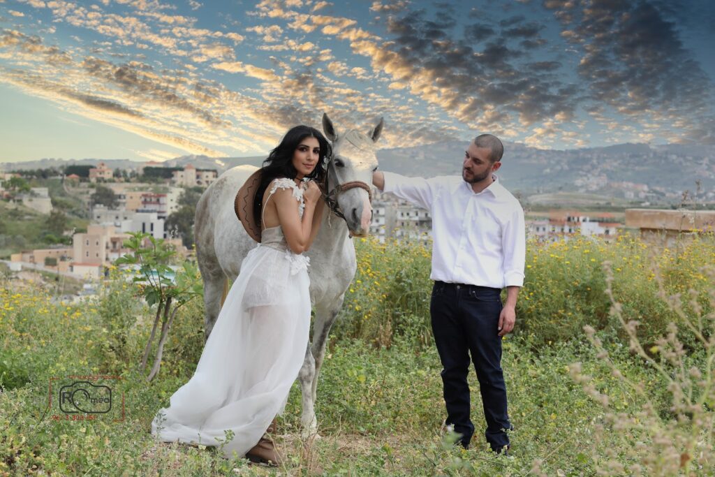 a man and woman standing next to a horse