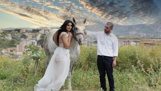 a man and woman standing next to a horse