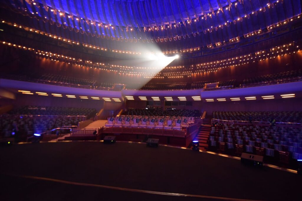 a large auditorium with rows of chairs and lights
