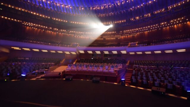 a large auditorium with rows of chairs and lights