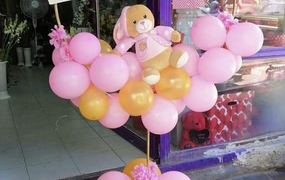 a pink and yellow balloon display