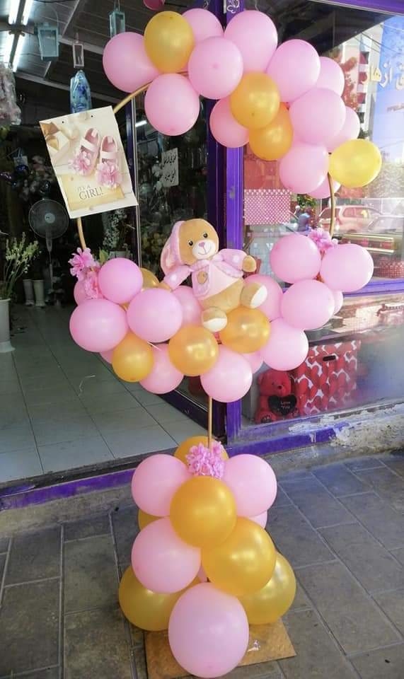 a pink and yellow balloon display