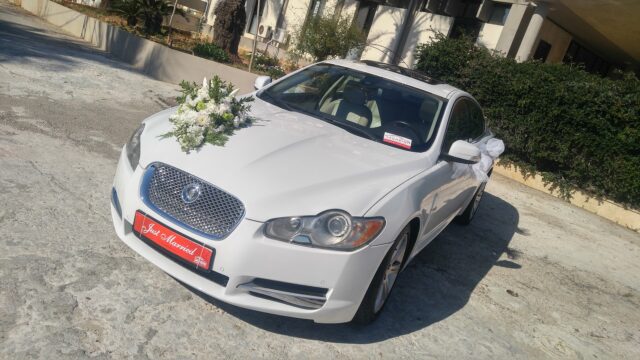 a white car with flowers on the hood