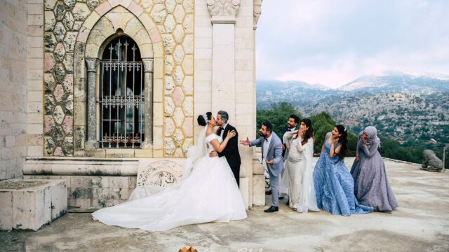 a group of people kissing in front of a building