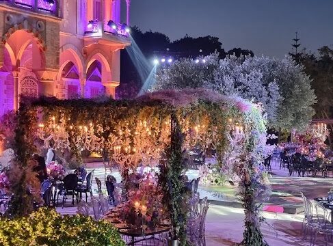 a building with purple lights and tables and chairs