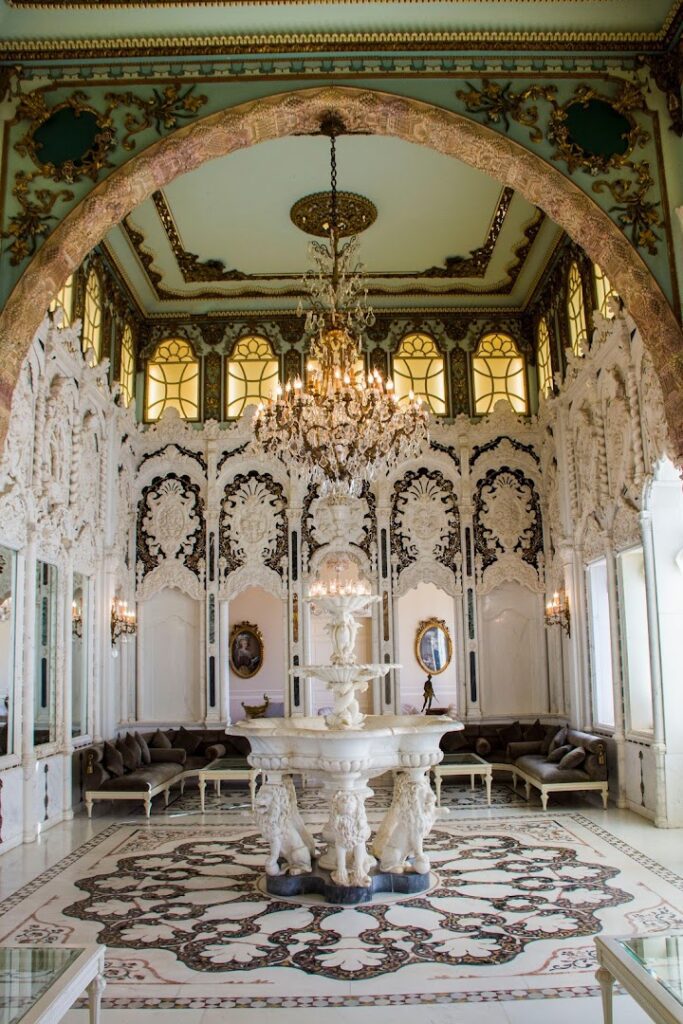 a white room with a fountain and chandelier