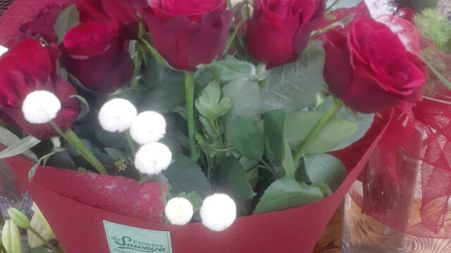 a bouquet of red roses and white flowers