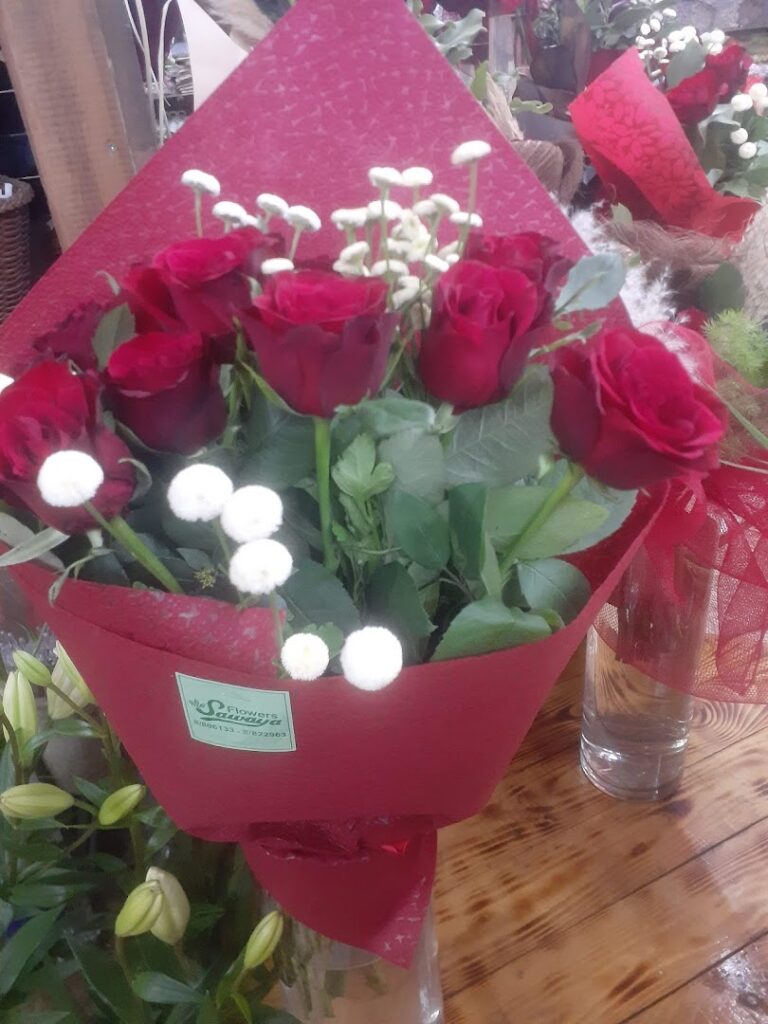 a bouquet of red roses and white flowers
