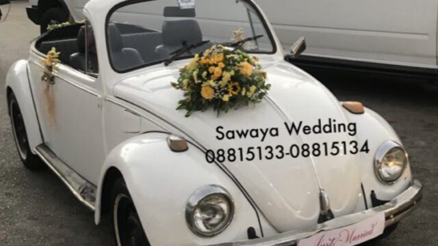 a white car with flowers on the hood