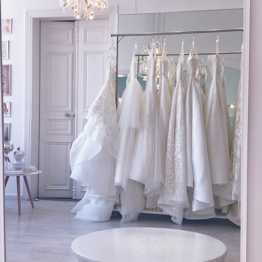 a room with white dresses on swingers