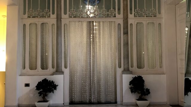 a room with a round white table and a chandelier