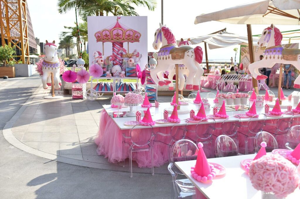 a table with pink and white decorations