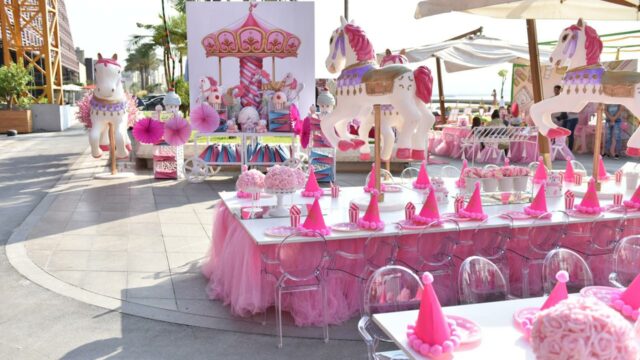 a table with pink and white decorations