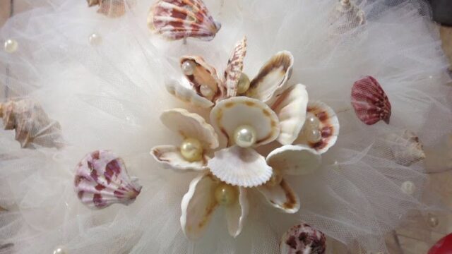 a white tulle and seashell bouquet