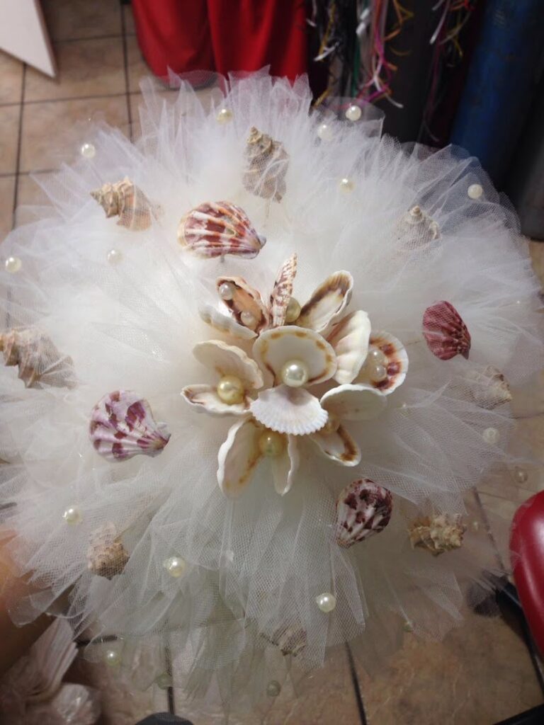 a white tulle and seashell bouquet