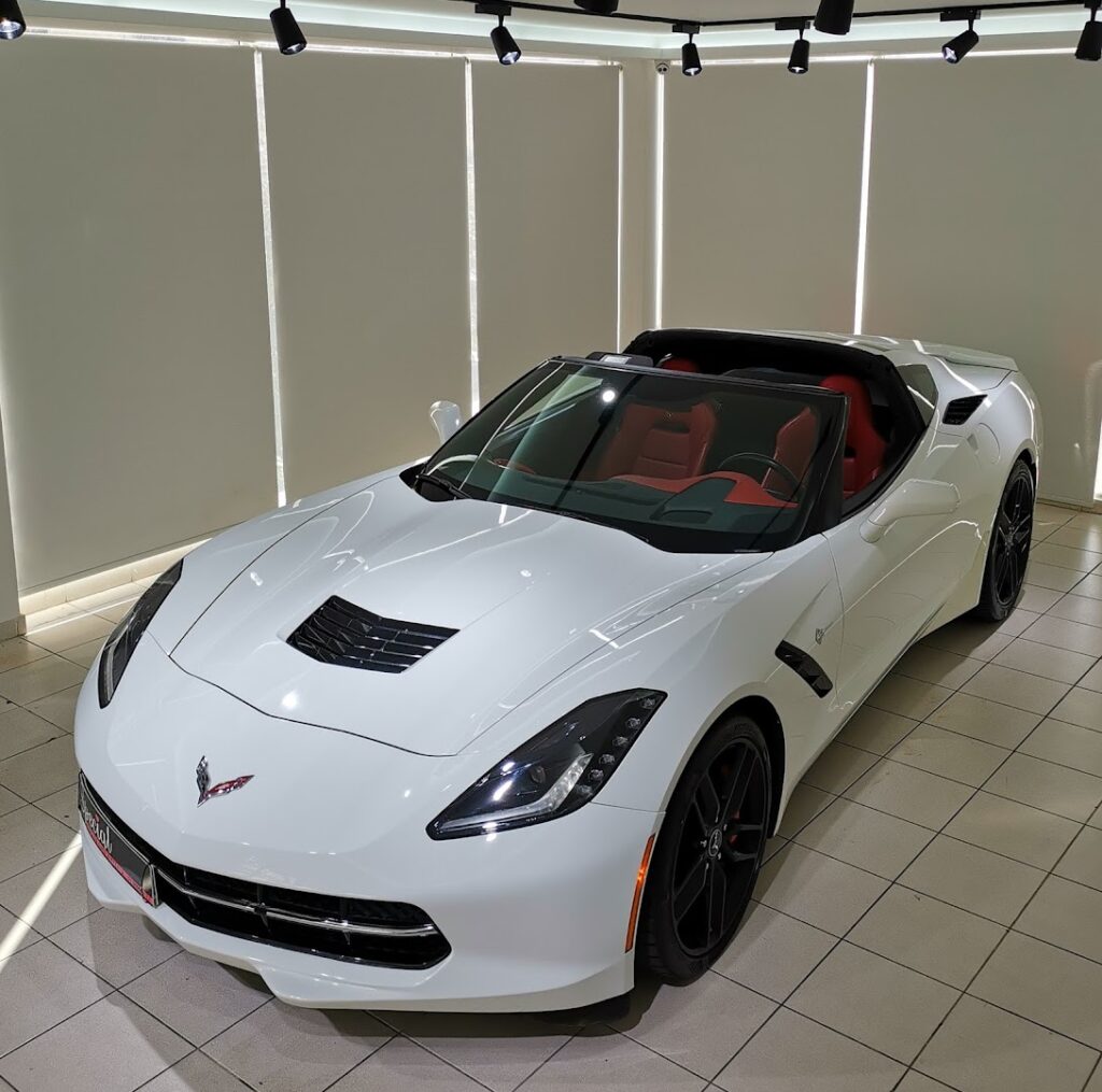 a white sports car in a showroom