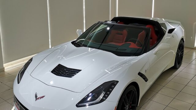 a white sports car in a showroom