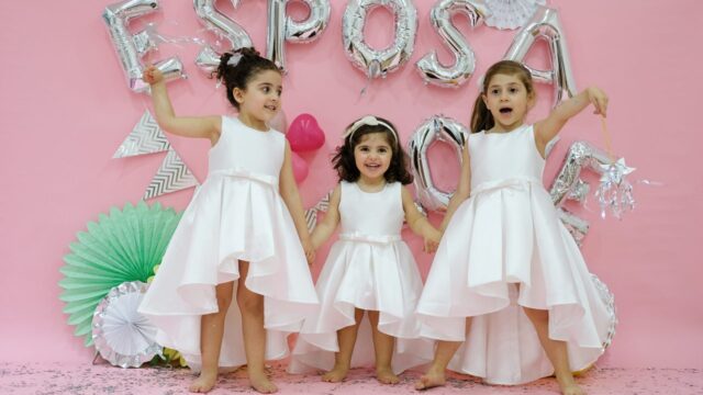 a group of girls in white dresses