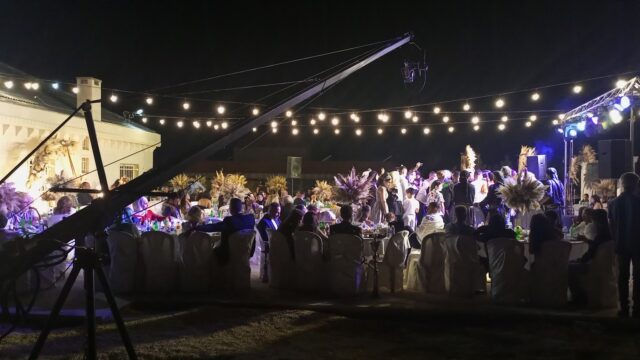 a group of people sitting around tables at night