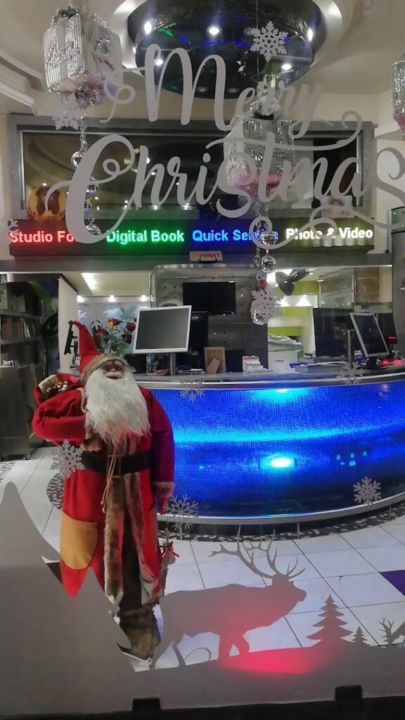 a santa claus standing in front of a store