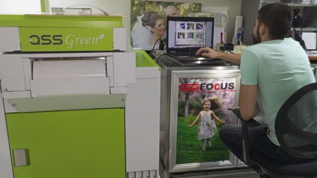 a woman sitting at a desk with a laptop