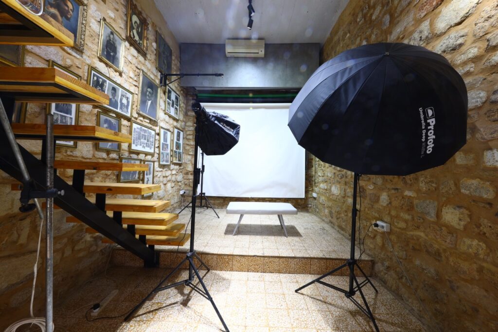 a photo studio with a bench and umbrella