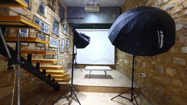 a photo studio with a bench and umbrella