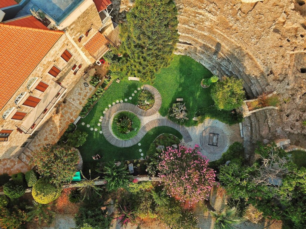 an aerial view of a garden and a building