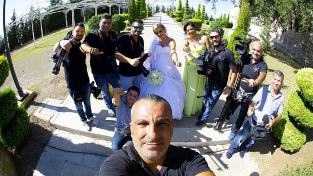 a man taking a selfie with a group of people