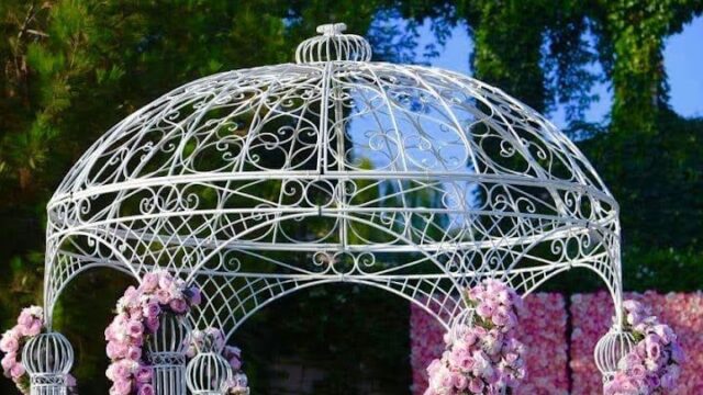 a white gazebo with pink flowers