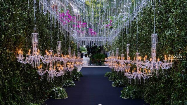 a path with chandeliers and flowers