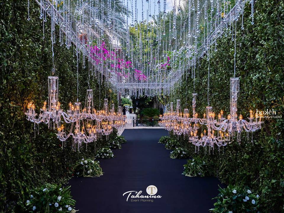 a path with chandeliers and flowers