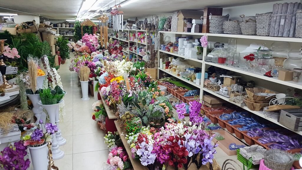 a room with shelves full of flowers