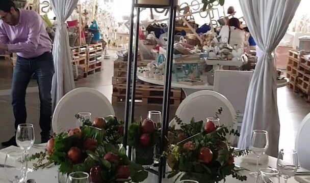 a table set with flowers and glasses