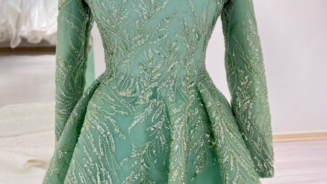 a green dress with gold sequins