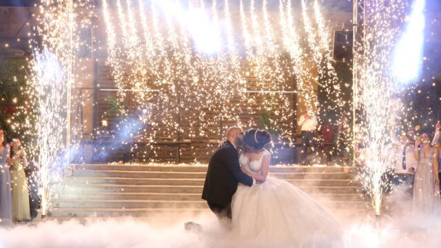 a man and woman kissing in front of fireworks