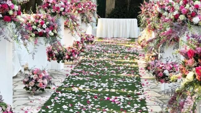 a wedding aisle with flowers and petals