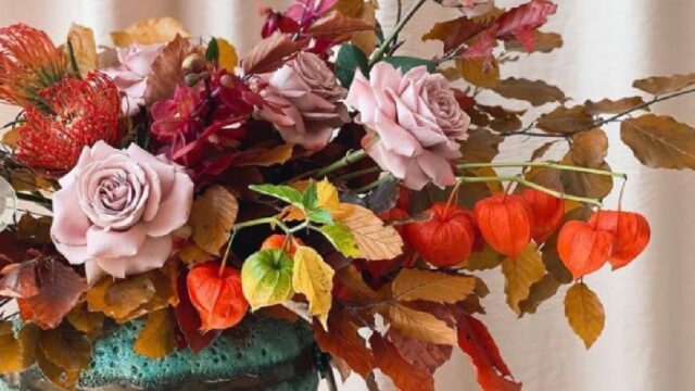 a vase with flowers and leaves