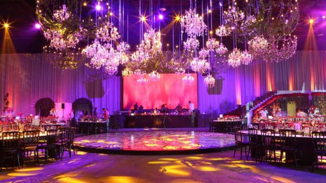 a room with chandeliers and tables