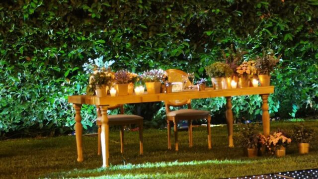 a table with flowers and candles on it