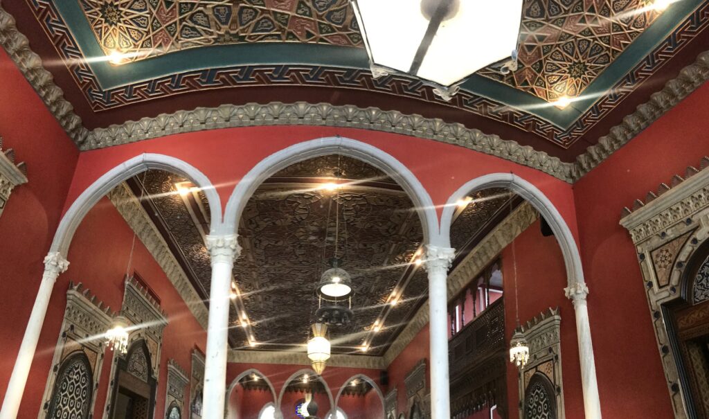 a red and white building with ornate ceiling and arches