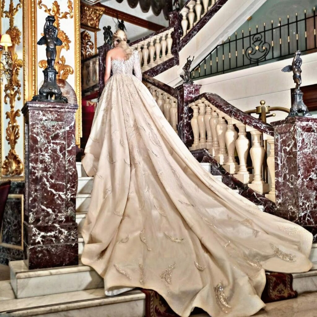 a woman in a long white dress on a staircase
